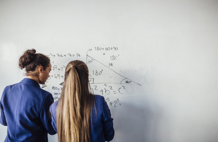 Girls working on a maths equation